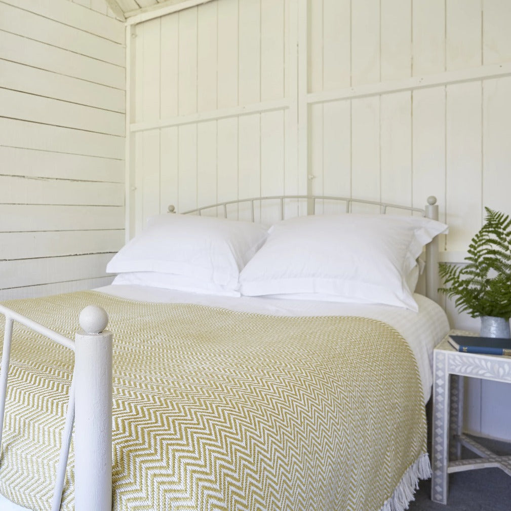 Herringbone Gooseberry Blanket on bed