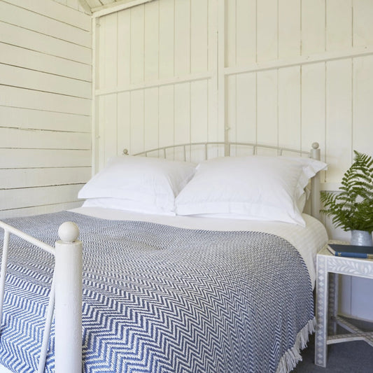 Navy Herringbone Blanket on a bed